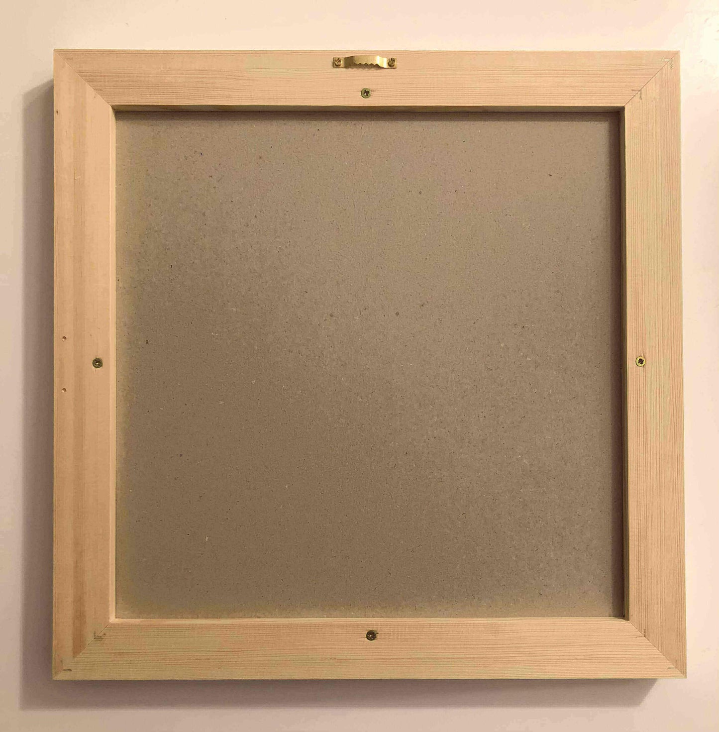 Empty wooden frame ready for canvas display, featuring secure backing and hanging hardware.